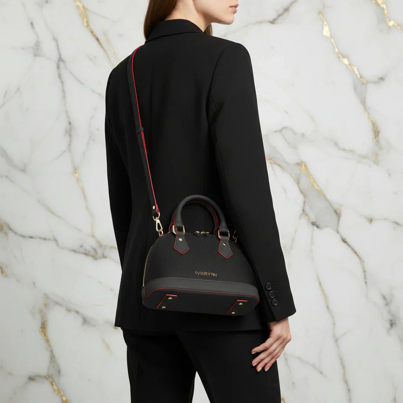 IVORYNN black bag worn crossbody - back angle on gold marble