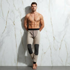 Leaning against wall ankles crossed