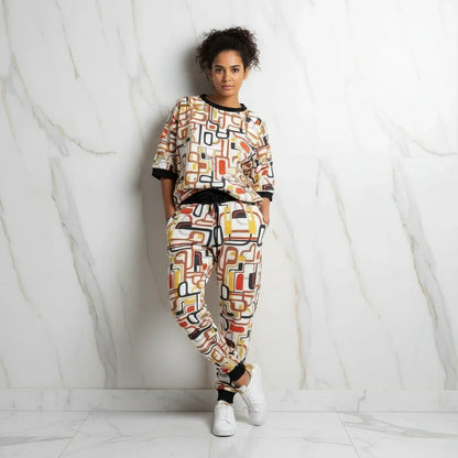 Leaning against wall, hands in pockets