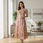 Woman in floral dress standing in modern living room with stylish furniture at Ivorynn