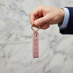 Man holding keychain - side angle