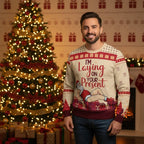 Man in Christmas sweater - By Christmas tree