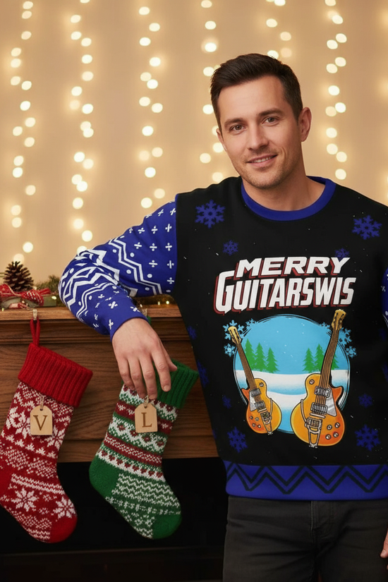 Man in Merry Guitarmas sweater - By mantle