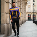 Man in sweatshirt against European building