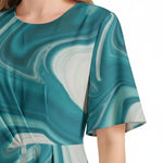 Woman wearing teal marble print dress with round neckline and short flutter sleeves from Ivorynn