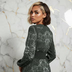 Woman wearing a stylish printed dress from Ivorynn, shown from the back, marble background