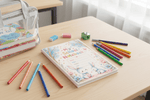Notebook lying flat with stationery
