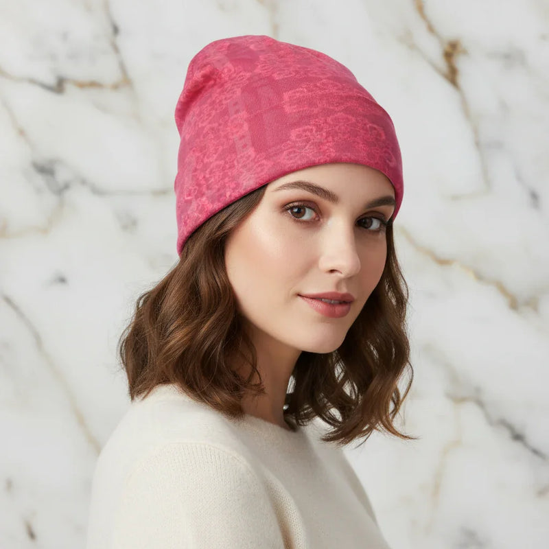 Woman wearing a pink floral knitted hat, angled front view, stylish winter accessory from Ivorynn