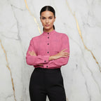 Woman in pink floral shirt and black pants poses with arms crossed, Ivorynn fashion apparel