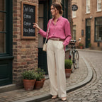 Woman in a pink floral shirt and cream trousers outside a cafe, stylish urban fashion by Ivorynn