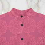 Pink floral jacquard shirt with black buttons and mandarin collar on marble background