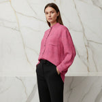 Woman wearing a pink floral shirt and black pants, stylish apparel Ivorynn fashion