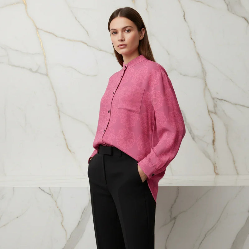 Woman wearing a pink floral shirt and black pants, stylish apparel Ivorynn fashion