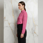 Woman in pink floral shirt and black pants side profile, modern fashion at Ivorynn