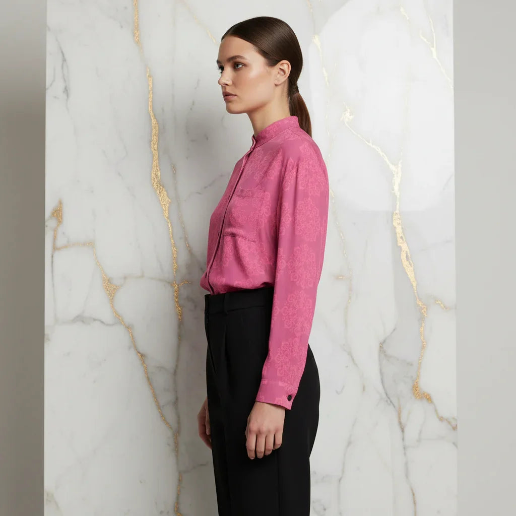 Woman in pink floral shirt and black pants side profile, modern fashion at Ivorynn