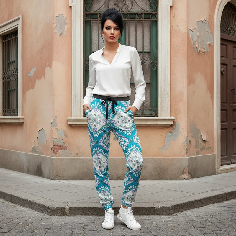 Stylish woman in white blouse and blue patterned pants on Italian street corner, Ivorynn fashion