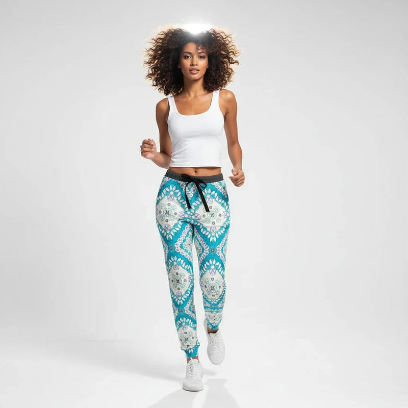 Woman modeling stylish blue patterned joggers and white tank top in studio, Ivorynn fashion