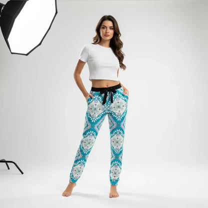 Woman modeling stylish blue patterned joggers and white crop top in professional studio