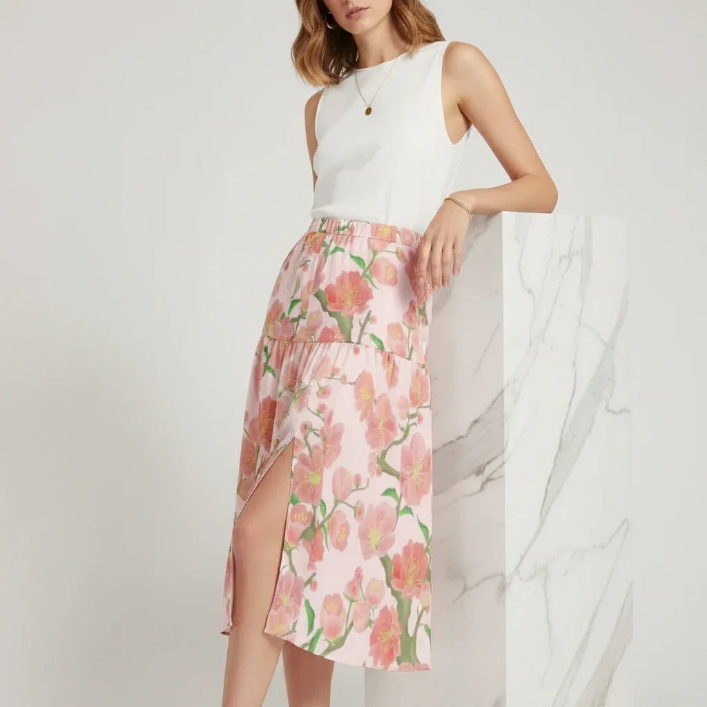 Woman modeling white sleeveless top and pink floral skirt, Ivorynn women's fashion apparel