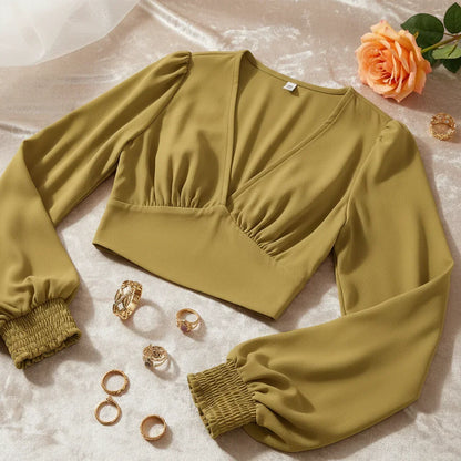 Side angle showing silhouette with vintage gold rings and apricot rose