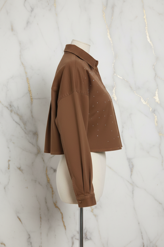 Side profile of brown denim shirt on marble background