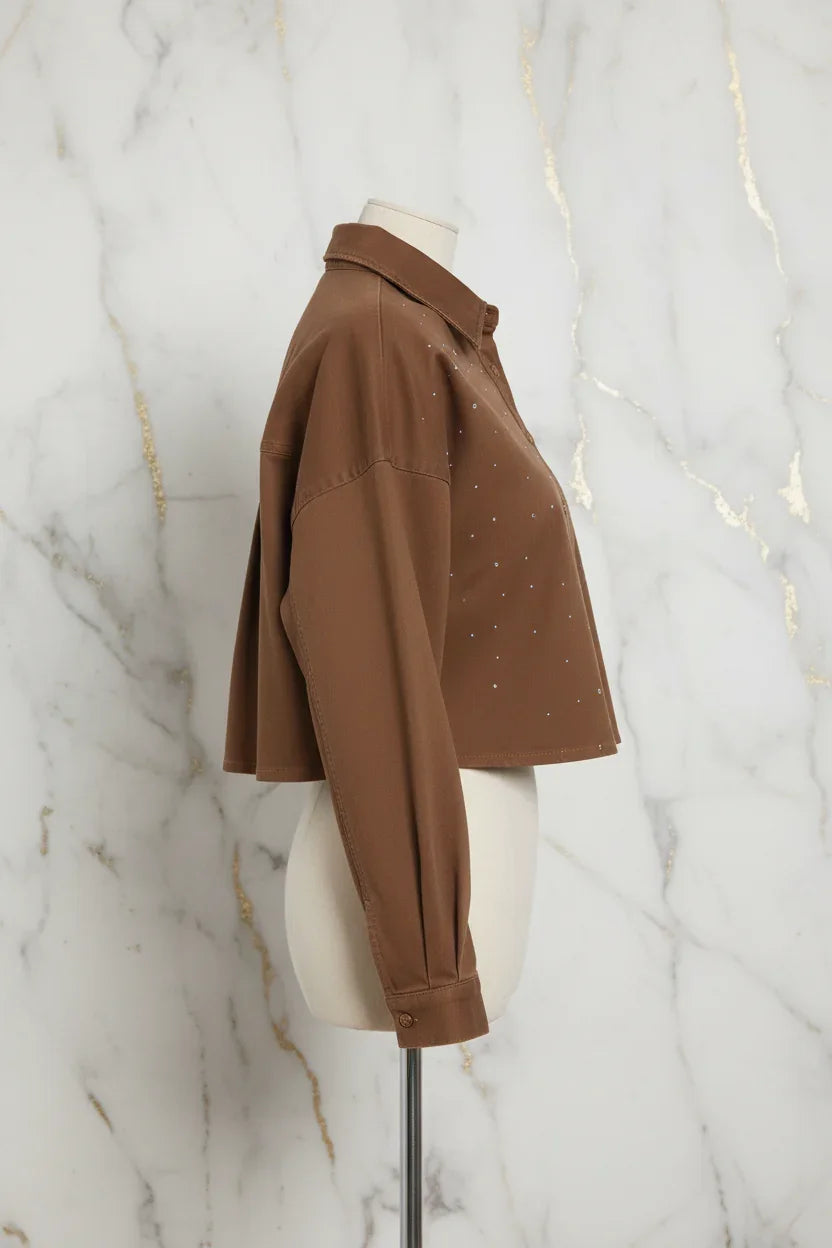 Side profile of brown denim shirt on marble background