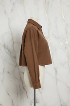 Side profile of brown denim shirt on marble background