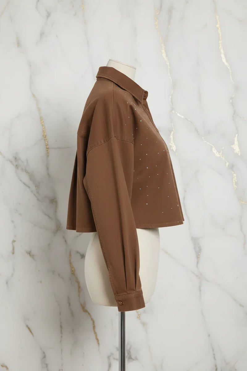 Side profile of brown denim shirt on marble background