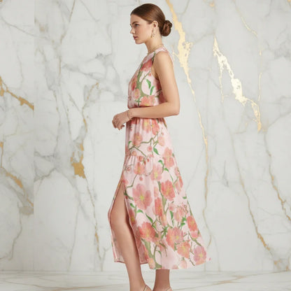 Woman in a floral sleeveless pink dress posing side profile against a marble backdrop at Ivorynn