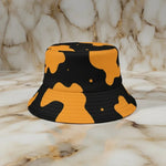 Yellow and black bucket hat with abstract pattern on marble surface at Ivorynn