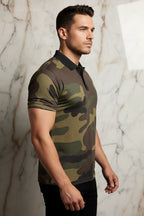 Man modeling camouflage polo shirt against marble wall at IVORYNN fashion store
