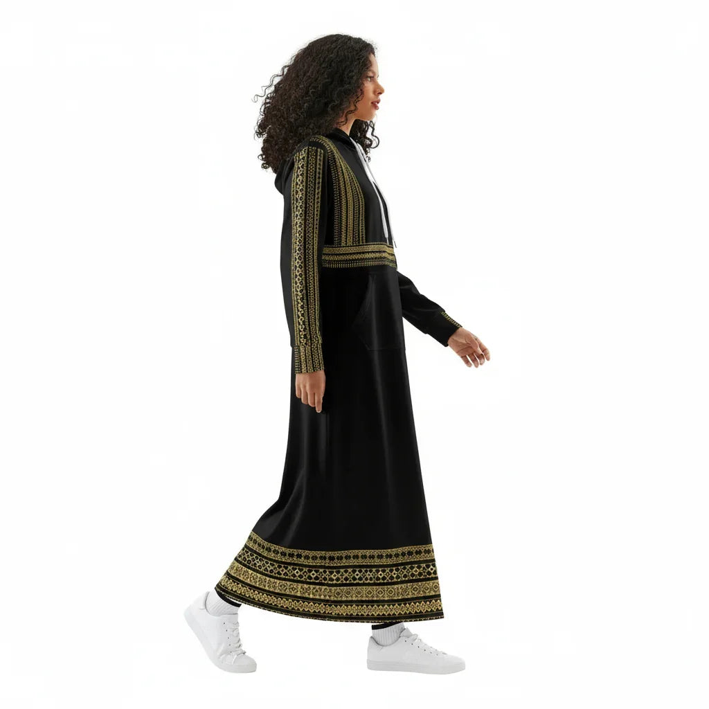 Woman in black and gold embroidered maxi dress with hoodie, walking, Ivorynn fashion