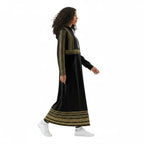Woman in black and gold embroidered maxi dress with hoodie, walking, Ivorynn fashion