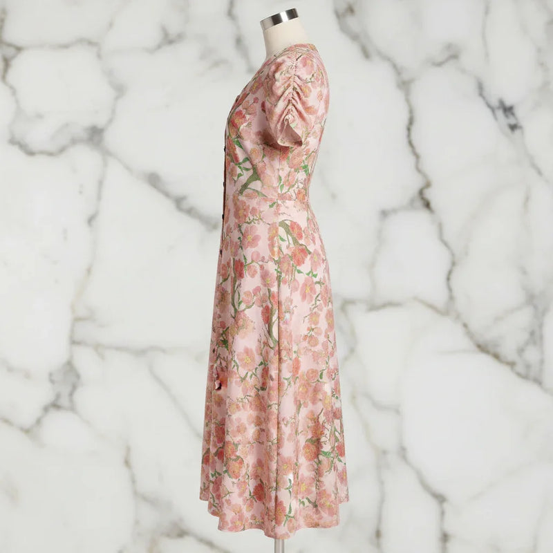 Side view of floral pink midi dress on mannequin, stylish women's fashion from Ivorynn