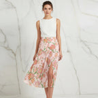 Woman in sleeveless white top and floral pink slit skirt, stylish fashion at Ivorynn.