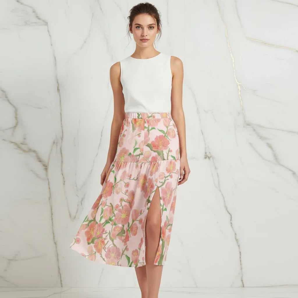 Woman in sleeveless white top and floral pink slit skirt, stylish fashion at Ivorynn.