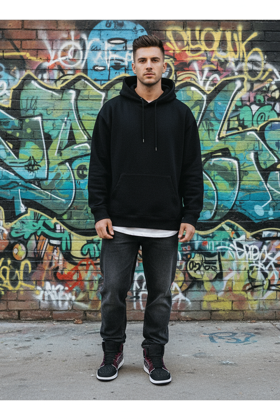 Standing in front of graffiti wall