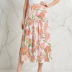 Woman modeling pink floral maxi skirt with left slit, stylish fashion from Ivorynn