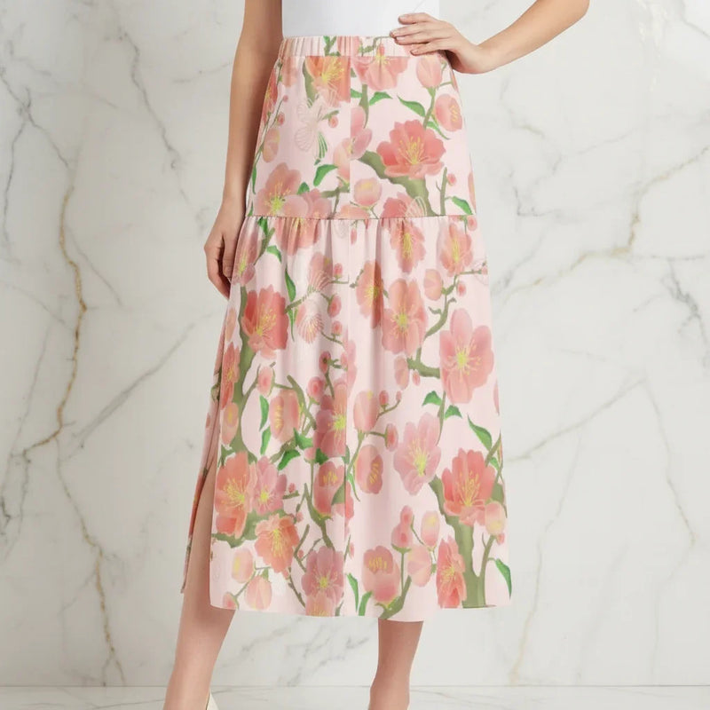 Woman modeling pink floral maxi skirt with left slit, stylish fashion from Ivorynn
