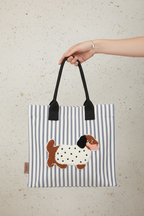Striped Dog Bag in Hand - Concrete Background