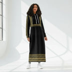 Woman modeling a black and gold long hoodie dress in a sunlit studio for Ivorynn fashion