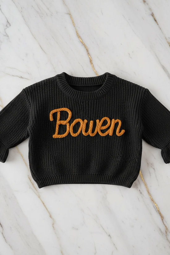 Sweater laid flat on marble