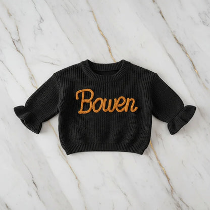 Sweater laid flat on marble