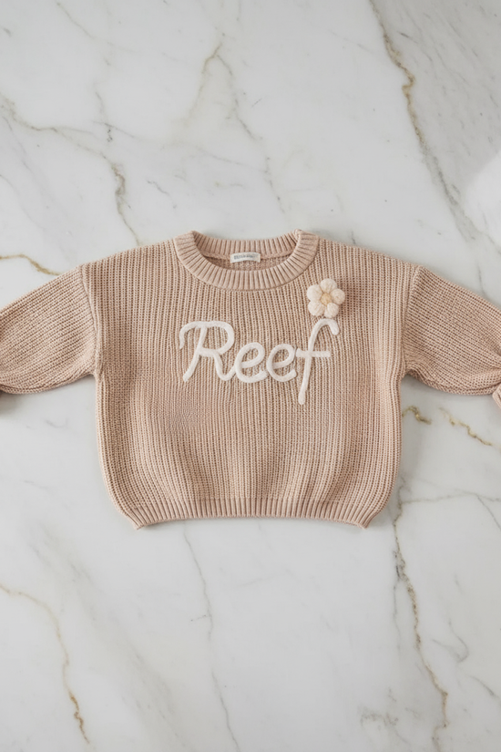 Sweater laid flat on marble