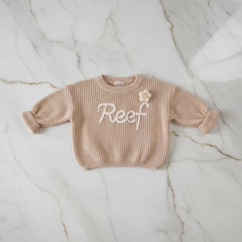 Sweater laid flat on marble