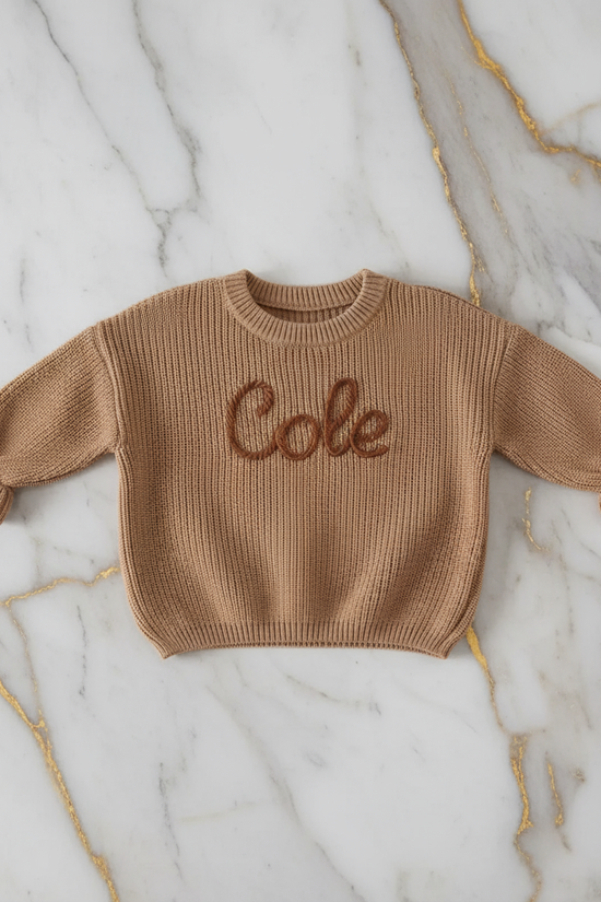 Sweater laid flat on marble