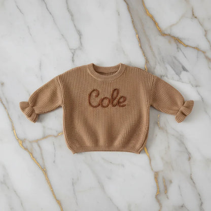 Sweater laid flat on marble