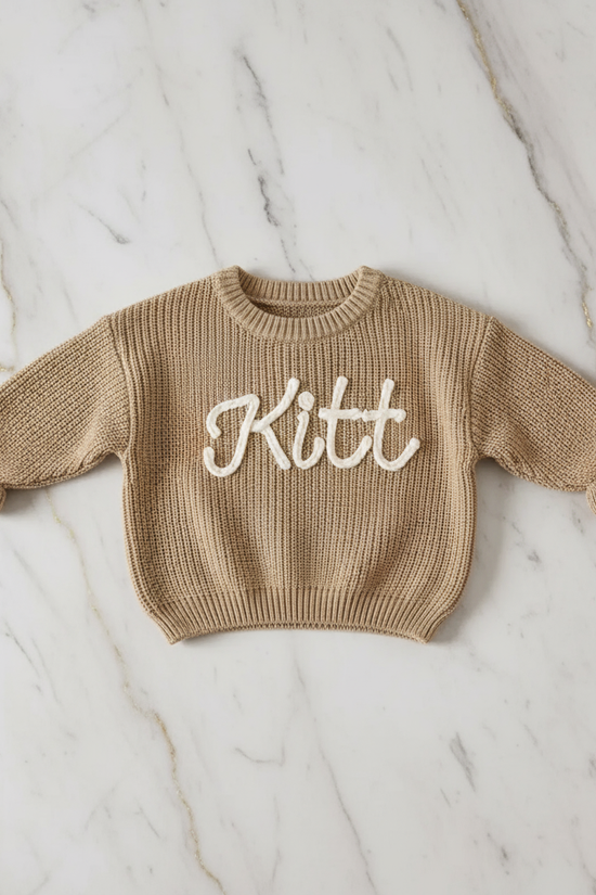 Sweater laid flat on marble