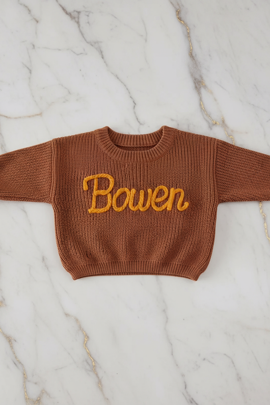 Sweater laid flat on marble