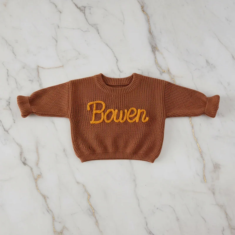 Sweater laid flat on marble